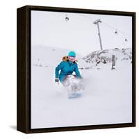 Young Woman Snowboarder in Motion on Snowboard in Mountains-Maxim Blinkov-Framed Stretched Canvas
