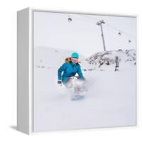 Young Woman Snowboarder in Motion on Snowboard in Mountains-Maxim Blinkov-Framed Stretched Canvas