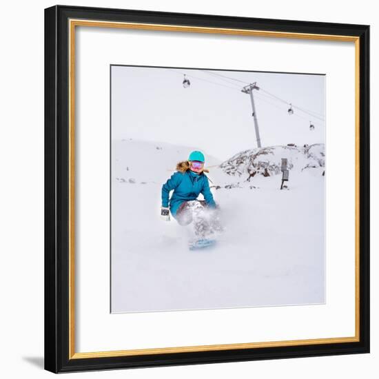 Young Woman Snowboarder in Motion on Snowboard in Mountains-Maxim Blinkov-Framed Photographic Print