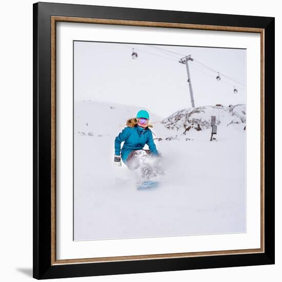 Young Woman Snowboarder in Motion on Snowboard in Mountains-Maxim Blinkov-Framed Photographic Print