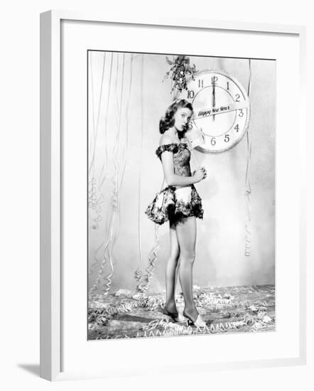 Young Woman Standing in Front of a Clock, Celebrating New Years Eve-null-Framed Photo