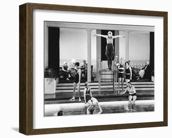 Young Woman Standing on a Diving Board Surrounded by a Group of People Playing-null-Framed Photo