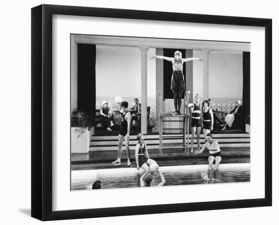Young Woman Standing on a Diving Board Surrounded by a Group of People Playing-null-Framed Photo