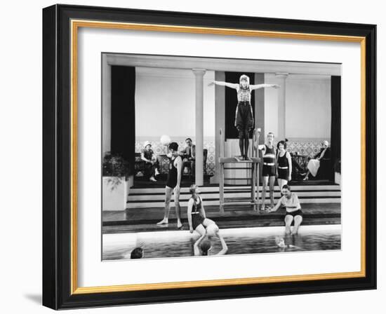 Young Woman Standing on a Diving Board Surrounded by a Group of People Playing-null-Framed Photo