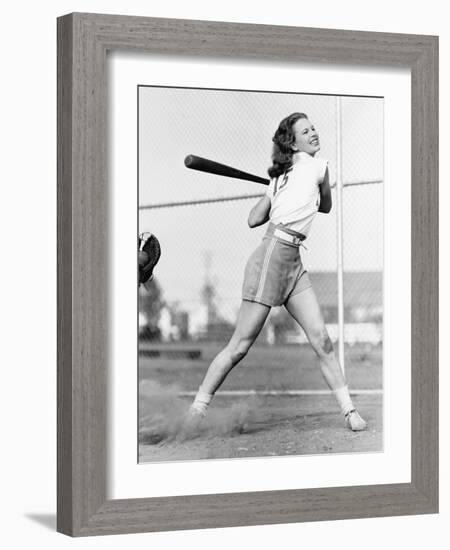 Young Woman Swinging a Baseball Bat in a Baseball Field-Everett Collection-Framed Photographic Print