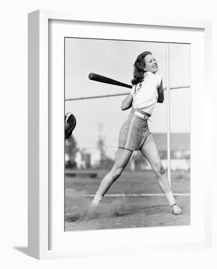 Young Woman Swinging a Baseball Bat in a Baseball Field-Everett Collection-Framed Photographic Print