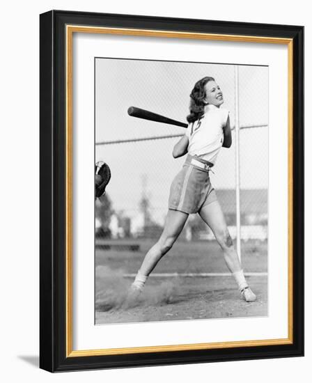 Young Woman Swinging a Baseball Bat in a Baseball Field-Everett Collection-Framed Photographic Print