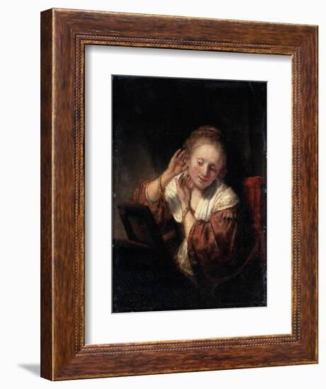 Young Woman Trying on Earrings, 1657-Rembrandt van Rijn-Framed Giclee Print