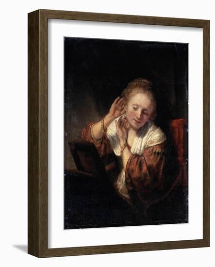 Young Woman Trying on Earrings, 1657-Rembrandt van Rijn-Framed Giclee Print