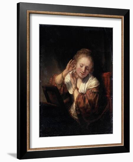 Young Woman Trying on Earrings, 1657-Rembrandt van Rijn-Framed Giclee Print