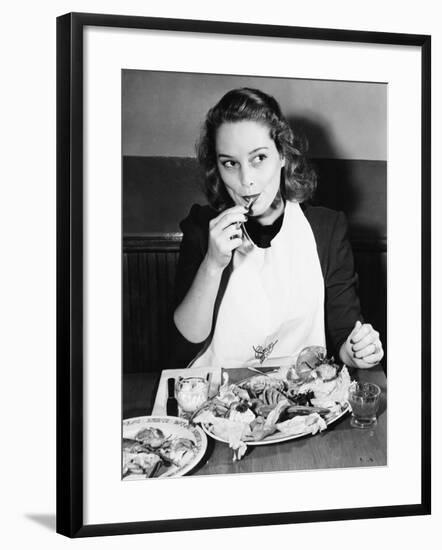 Young Woman with a Bib Eating Lobster-null-Framed Photo
