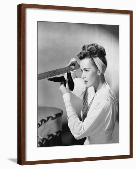 Young Woman with a Ruler Measuring Her Shoe-null-Framed Photo