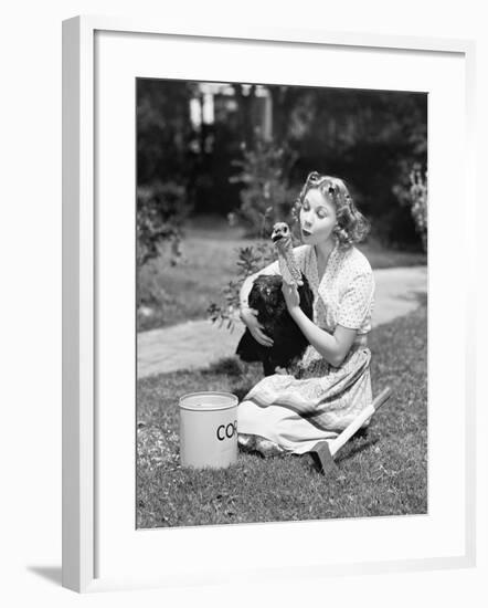 Young Woman, with an Ax Next to Her, Hugs a Turkey-null-Framed Photo