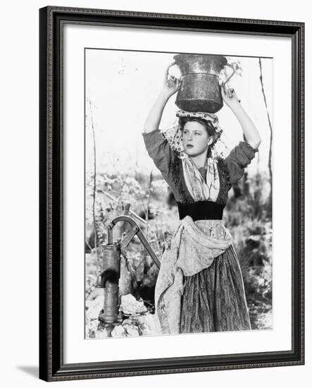 Young Woman with Water Bucket on Her Head Next to a Well--Framed Photo