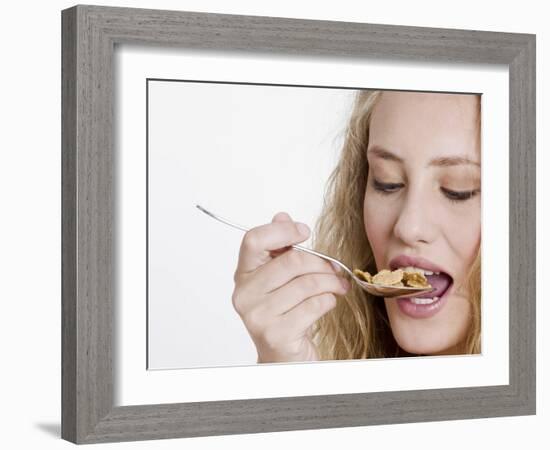 Young Womand Eating Cornflakes from a Spoon-null-Framed Photographic Print