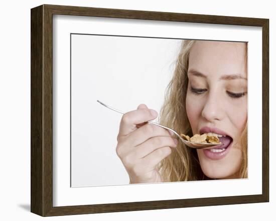 Young Womand Eating Cornflakes from a Spoon-null-Framed Photographic Print