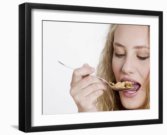 Young Womand Eating Cornflakes from a Spoon-null-Framed Photographic Print