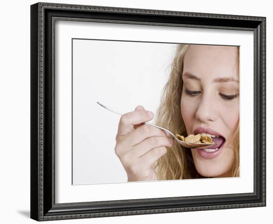 Young Womand Eating Cornflakes from a Spoon-null-Framed Photographic Print