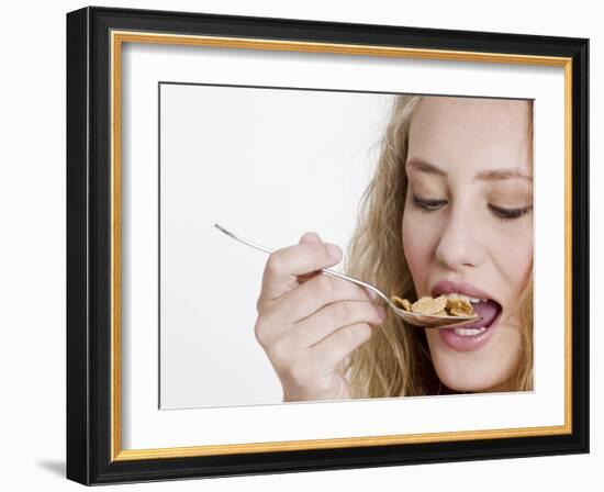 Young Womand Eating Cornflakes from a Spoon-null-Framed Photographic Print