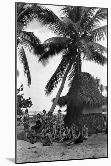 Young Women in Polynesian-Flapper Costumes Lounge under a Coconut Palm-null-Mounted Photographic Print