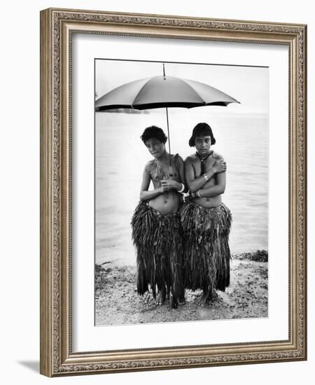 Young Yap Island ladies sporting traditional Grass Skirts, Sharing umbrella in the Caroline Islands-Eliot Elisofon-Framed Photographic Print