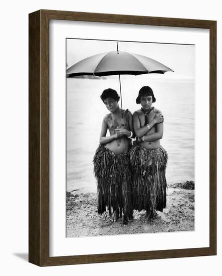 Young Yap Island ladies sporting traditional Grass Skirts, Sharing umbrella in the Caroline Islands-Eliot Elisofon-Framed Photographic Print