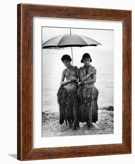 Young Yap Island ladies sporting traditional Grass Skirts, Sharing umbrella in the Caroline Islands-Eliot Elisofon-Framed Photographic Print