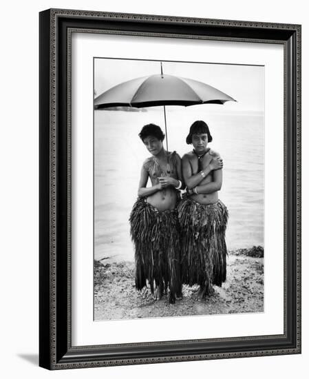 Young Yap Island ladies sporting traditional Grass Skirts, Sharing umbrella in the Caroline Islands-Eliot Elisofon-Framed Photographic Print