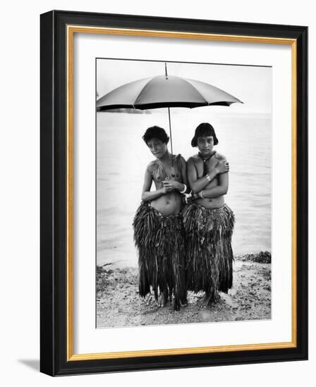 Young Yap Island ladies sporting traditional Grass Skirts, Sharing umbrella in the Caroline Islands-Eliot Elisofon-Framed Photographic Print