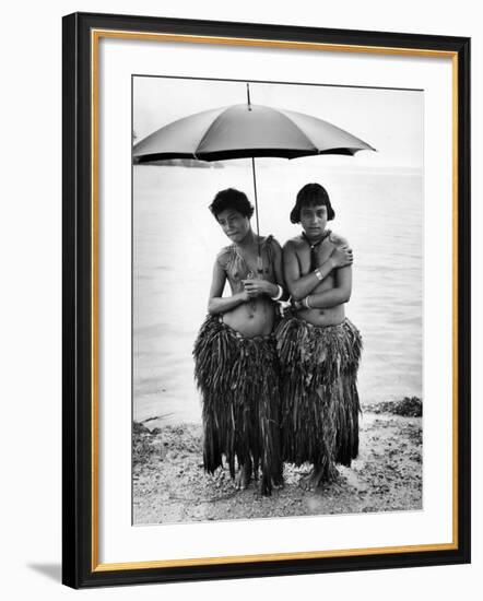 Young Yap Island ladies sporting traditional Grass Skirts, Sharing umbrella in the Caroline Islands-Eliot Elisofon-Framed Photographic Print