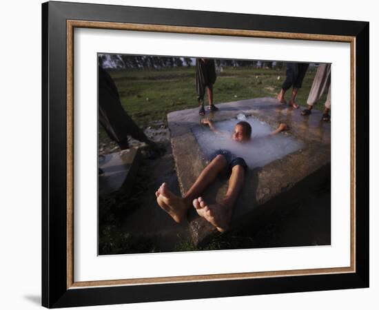 Youth Swims in a Water Reservoir as the Temperature Rises, on the Outskirts of Islamabad, Pakistan-null-Framed Photographic Print