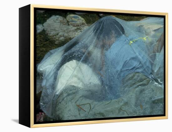 Youths Huddled under a Piece of Clear Plastic in the Rain, Woodstock Music and Art Fair-John Dominis-Framed Premier Image Canvas