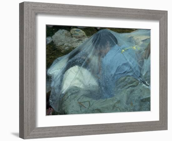 Youths Huddled under a Piece of Clear Plastic in the Rain, Woodstock Music and Art Fair-John Dominis-Framed Photographic Print